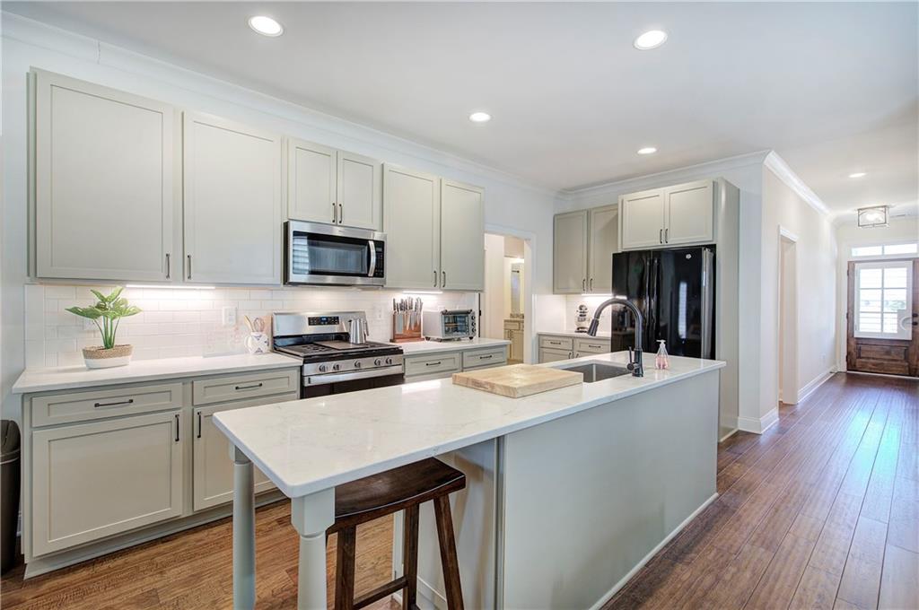 6 Encore Lane Cartersville, GA 30120 - Photo 5 of 33 a kitchen with a stove a sink a microwave a refrigerator and cabinets