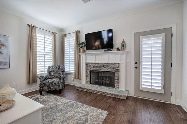 a living room with furniture and a ceiling fan