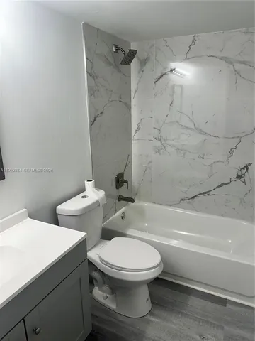 a bathroom with a toilet and a bathtub