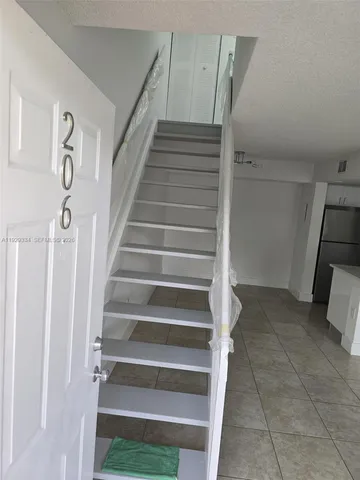 a view of staircase with white walls and a window