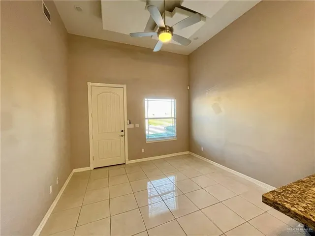 a view of an empty room and window chandelier fan