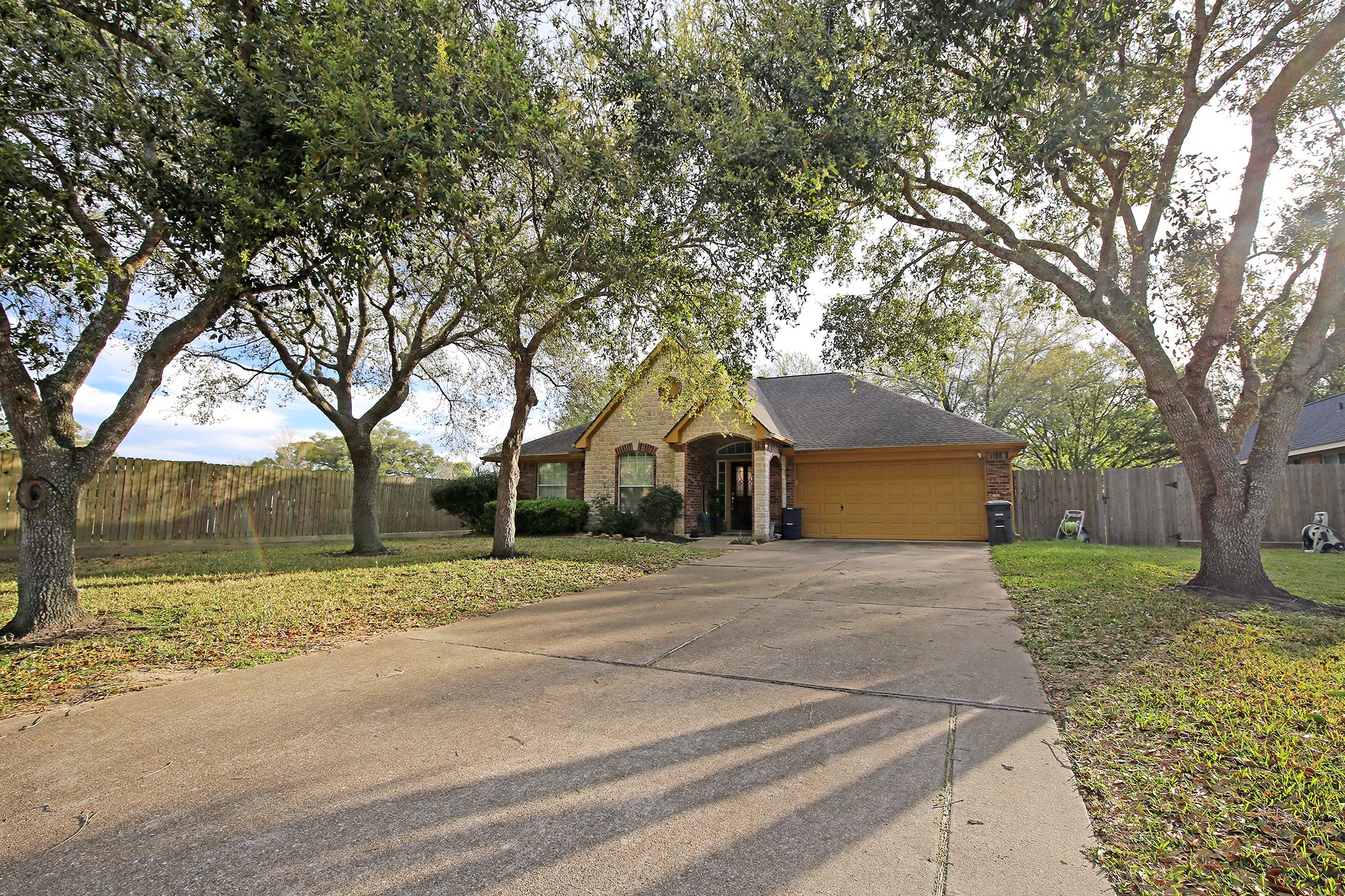 907 Riverside Drive Alvin, TX 77511 - Photo 2 of 31 Double Driveway under some mature trees to keep your car shaded!
