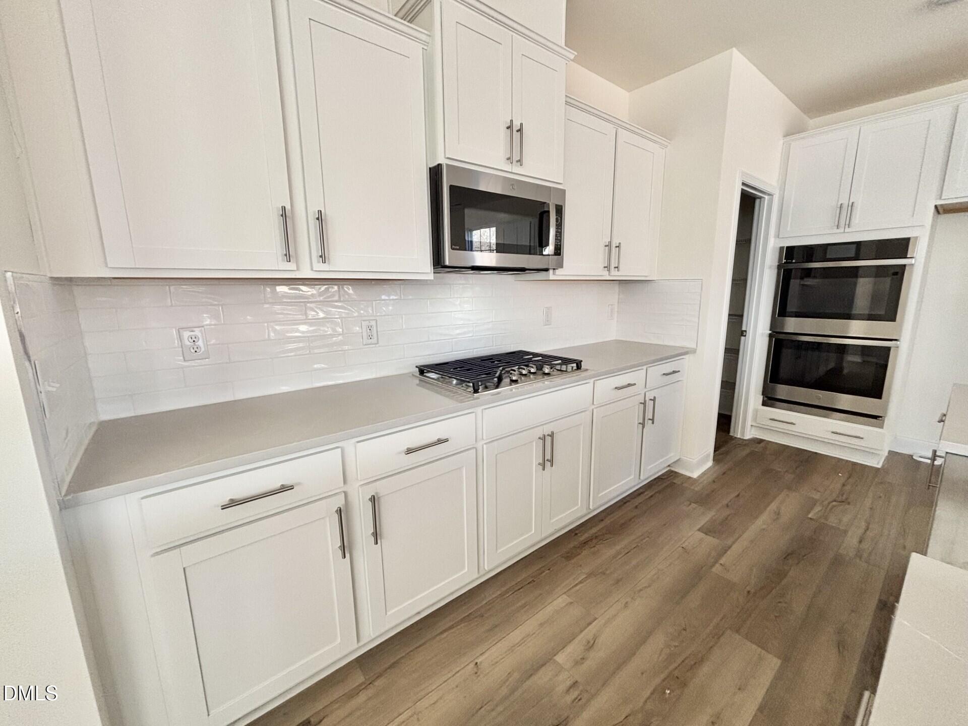 20 Gerrard Street, Unit 6 Franklinton, NC 27525 - Photo 11 of 31 a kitchen with granite countertop white cabinets and stainless steel appliances