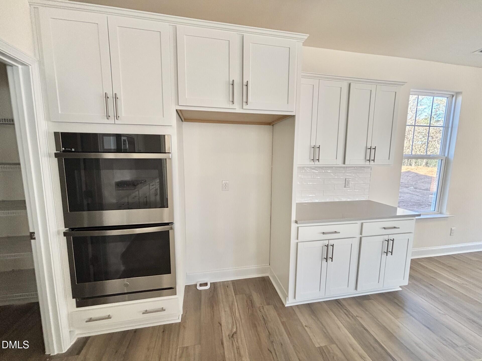 20 Gerrard Street, Unit 6 Franklinton, NC 27525 - Photo 13 of 31 a kitchen with granite countertop white cabinets and stainless steel appliances