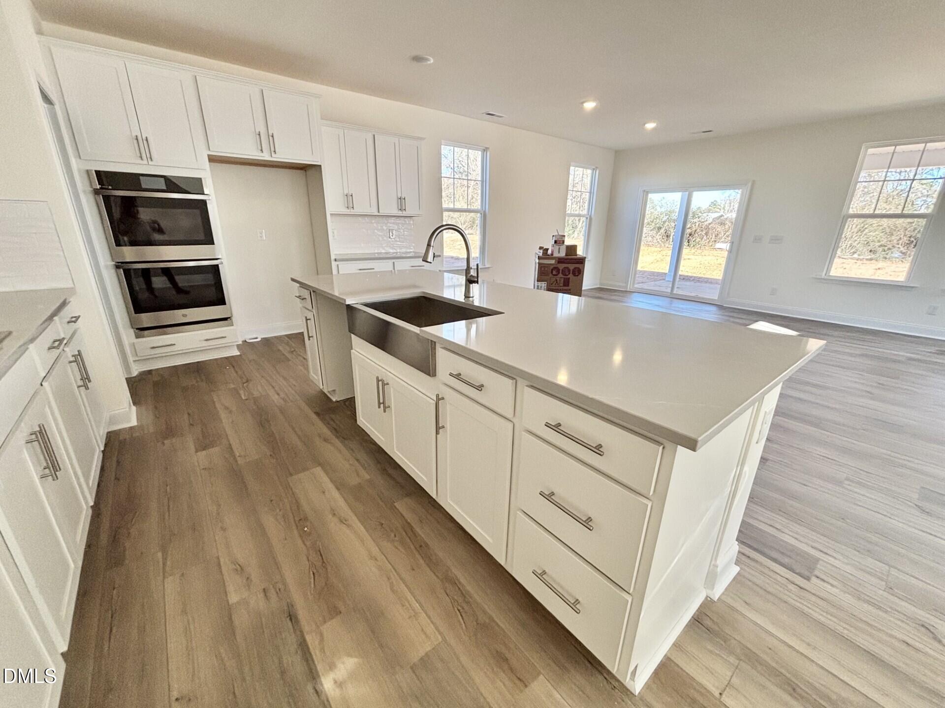20 Gerrard Street, Unit 6 Franklinton, NC 27525 - Photo 8 of 31 a kitchen with stainless steel appliances granite countertop a sink a stove a refrigerator and cabinets
