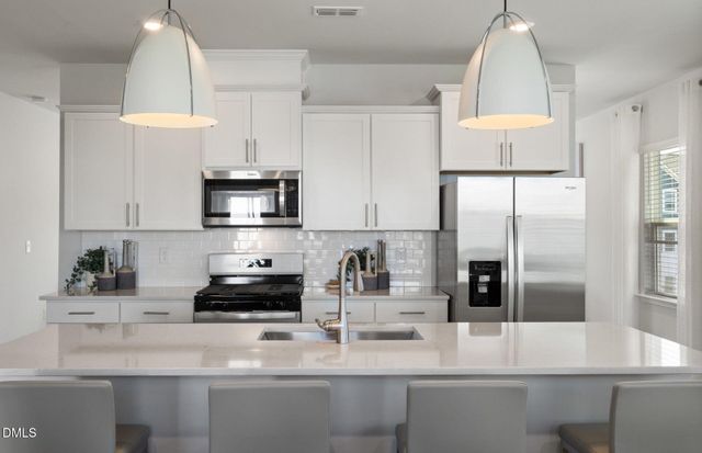 a picture of a bathroom with a refrigerator and a white refrigerator