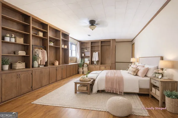 a bedroom with a large bed and a window