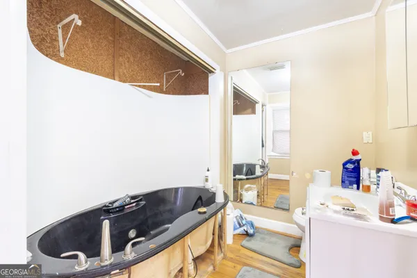 a bathroom with a granite countertop sink and a bathtub