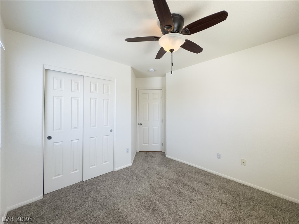 9456 Grandview Spring Avenue Las Vegas, NV 89166 - Photo 35 of 49 An inviting room features a ceiling fan, plush carpet, and ample storage.