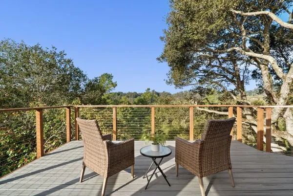 a view of a chair and table on the deck