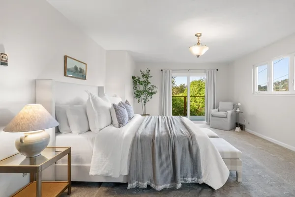 a spacious bedroom with a bed and window