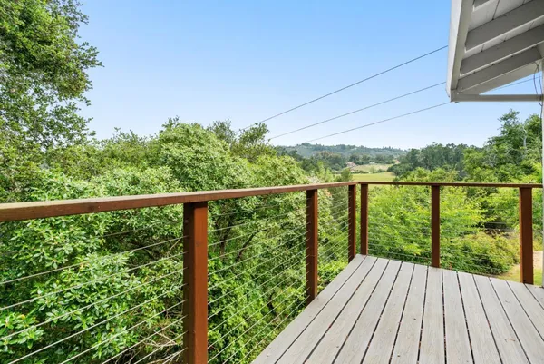a view of balcony with wooden floor