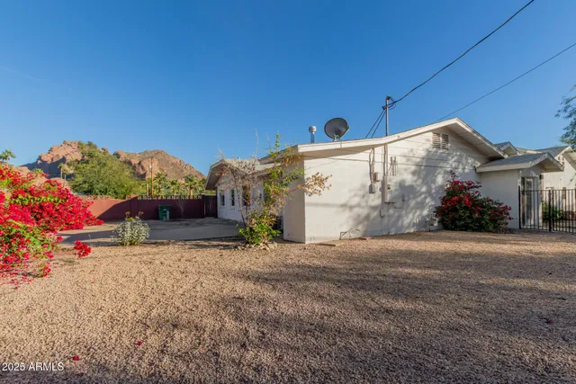 a view of a white house with a yard