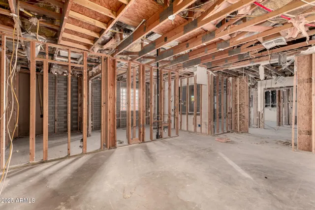 a roof deck with table and chairs and potted plants