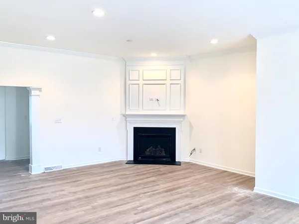 a view of empty room with a fireplace