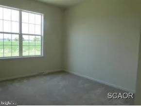 a view of empty room with floor to ceiling window