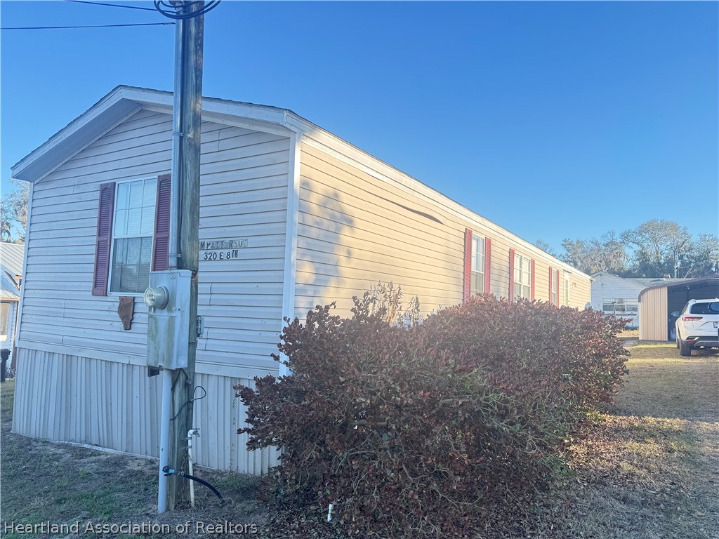 320 East 8th Street Frostproof, FL 33843 - Photo 1 of 17 a view of a house with backyard and trees