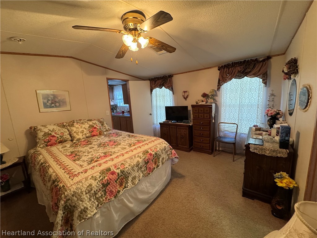 320 East 8th Street Frostproof, FL 33843 - Photo 5 of 17 a spacious bedroom with a bed and a chandelier