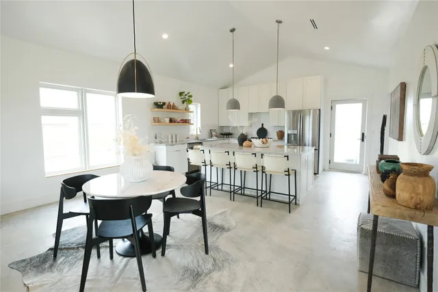 a large kitchen with a table and chairs