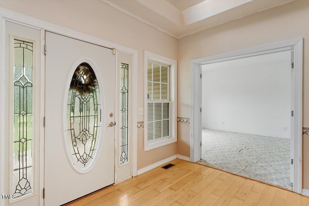 1175 Faulkner Town Road Henderson, NC 27537 - Photo 12 of 48 view of a livingroom with wooden floor windows and entryway