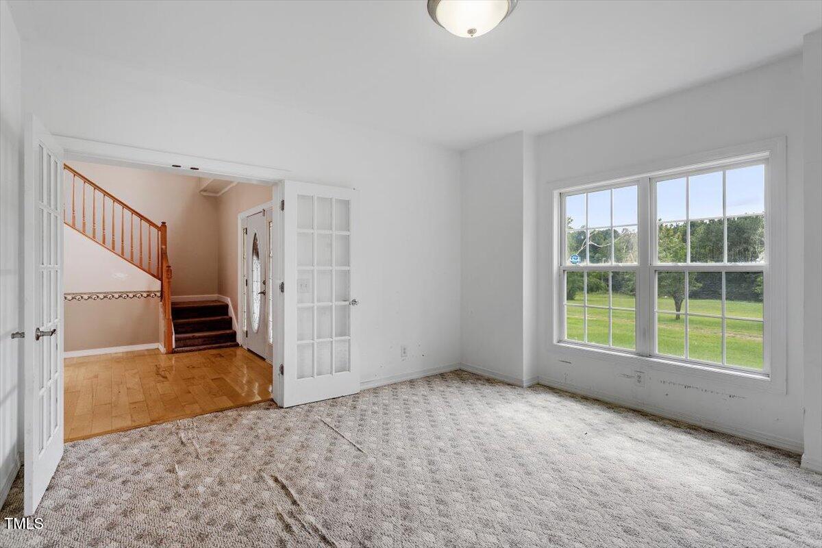 1175 Faulkner Town Road Henderson, NC 27537 - Photo 13 of 48 a view of an empty room with a window