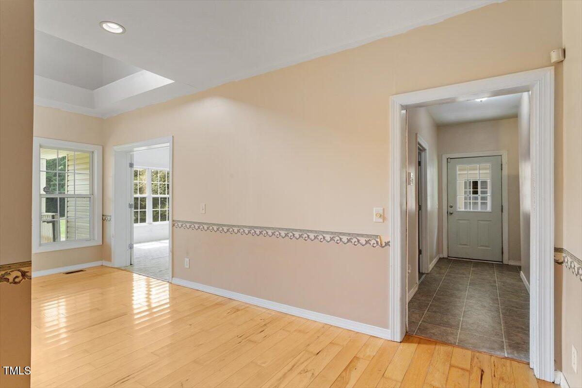 1175 Faulkner Town Road Henderson, NC 27537 - Photo 14 of 48 a view of a room with wooden floor and a bathroom