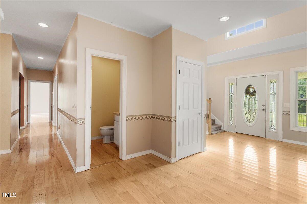 1175 Faulkner Town Road Henderson, NC 27537 - Photo 15 of 48 a view of a hallway with wooden floor