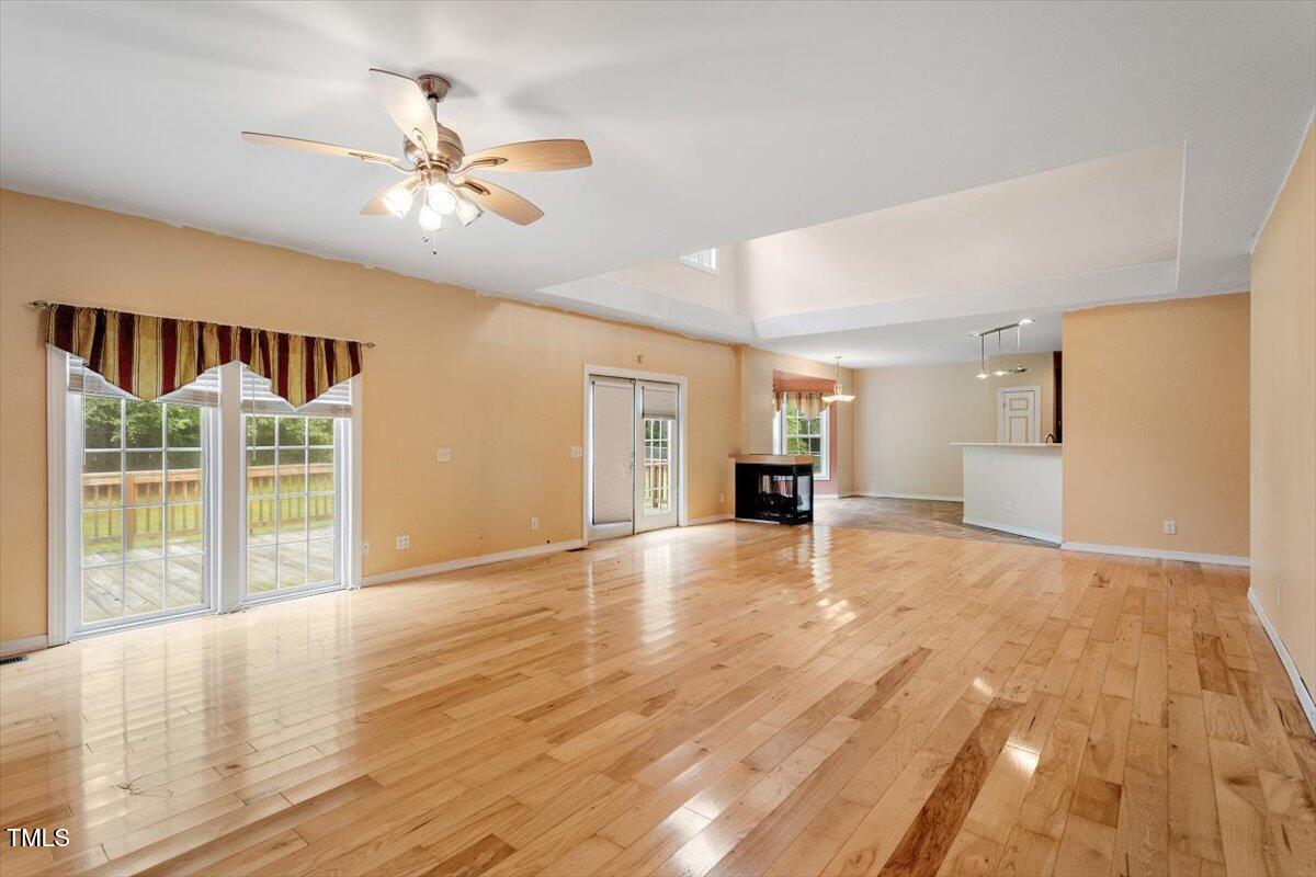 1175 Faulkner Town Road Henderson, NC 27537 - Photo 19 of 48 a view of an empty room with wooden floor and a window