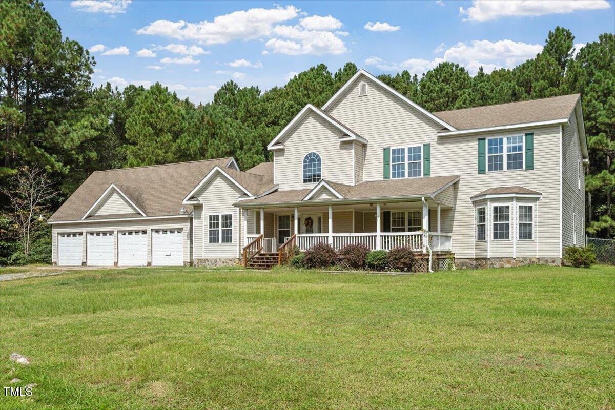 1175 Faulkner Town Road Henderson, NC 27537 - Photo 2 of 48 a front view of a house with a garden