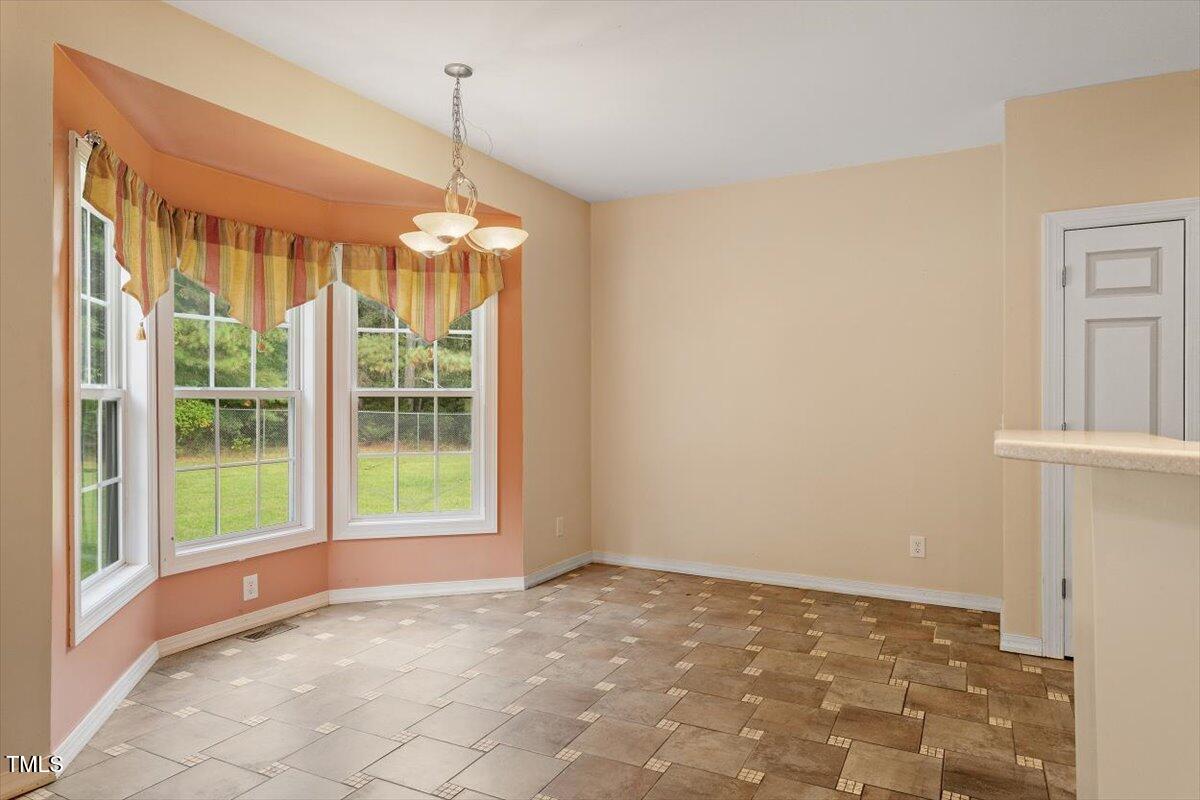 1175 Faulkner Town Road Henderson, NC 27537 - Photo 22 of 48 a view of an empty room with windows