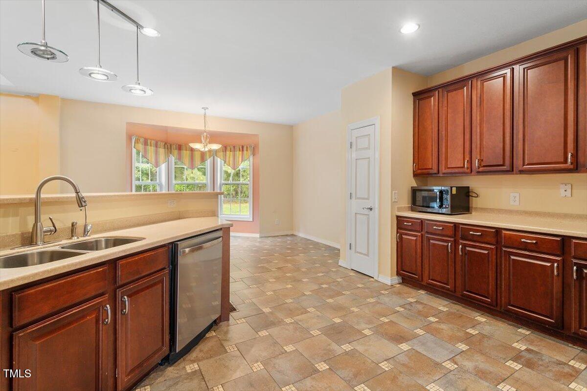 1175 Faulkner Town Road Henderson, NC 27537 - Photo 25 of 48 a kitchen with a sink and cabinets