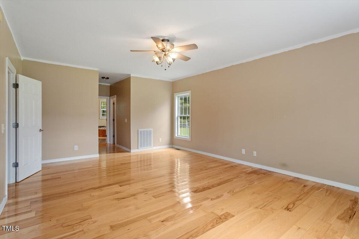 1175 Faulkner Town Road Henderson, NC 27537 - Photo 30 of 48 a view of an empty room with wooden floor