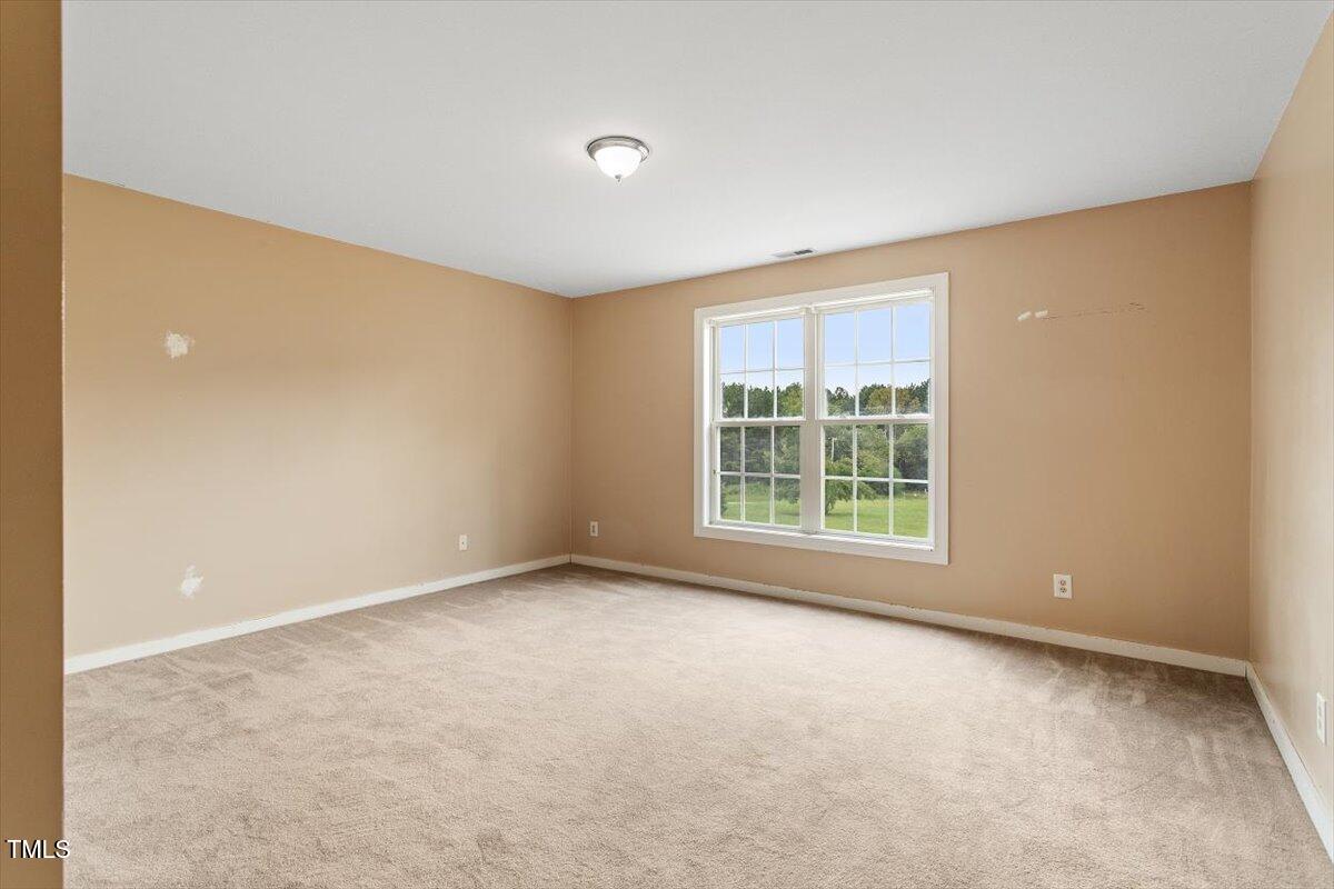 1175 Faulkner Town Road Henderson, NC 27537 - Photo 36 of 48 a view of an empty room with a window