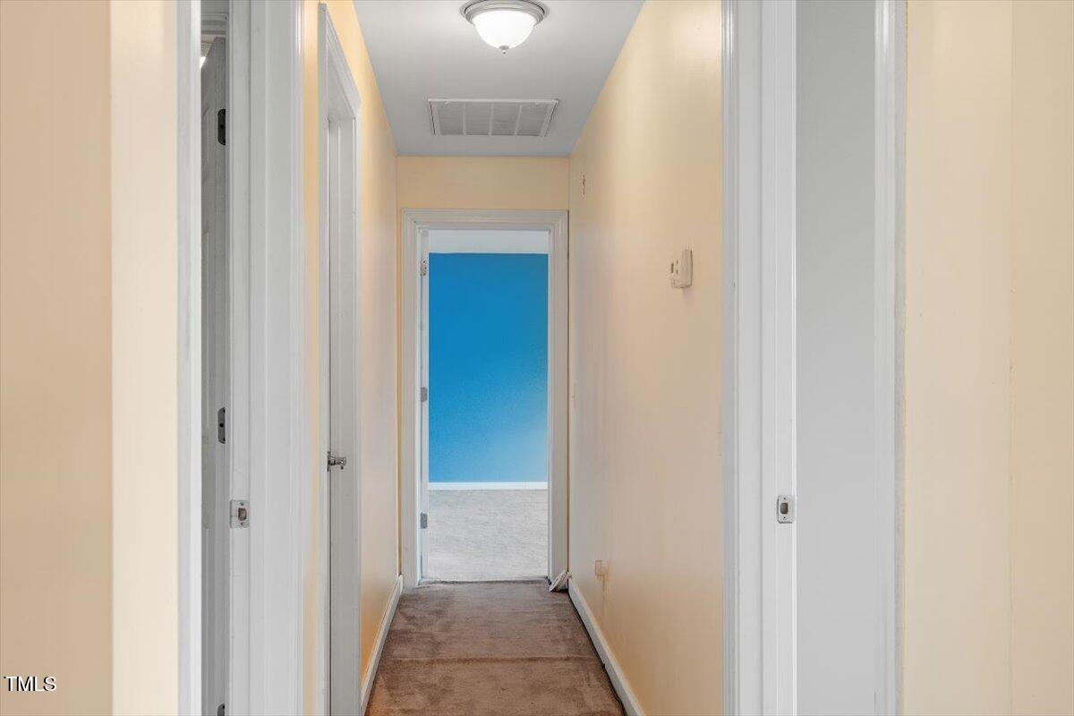 1175 Faulkner Town Road Henderson, NC 27537 - Photo 37 of 48 a view of a hallway with a white door
