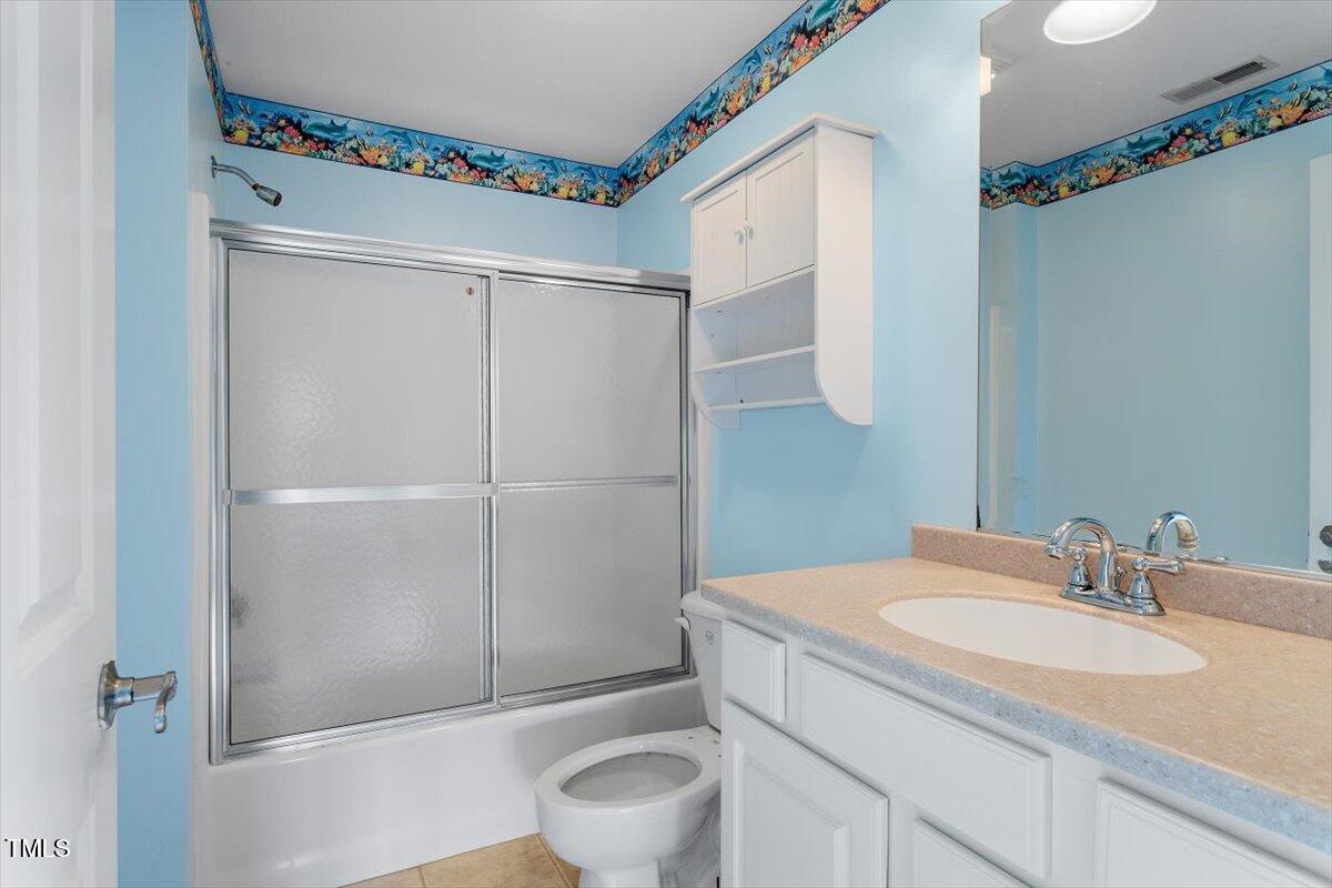 1175 Faulkner Town Road Henderson, NC 27537 - Photo 46 of 48 a bathroom with a sink and a mirror