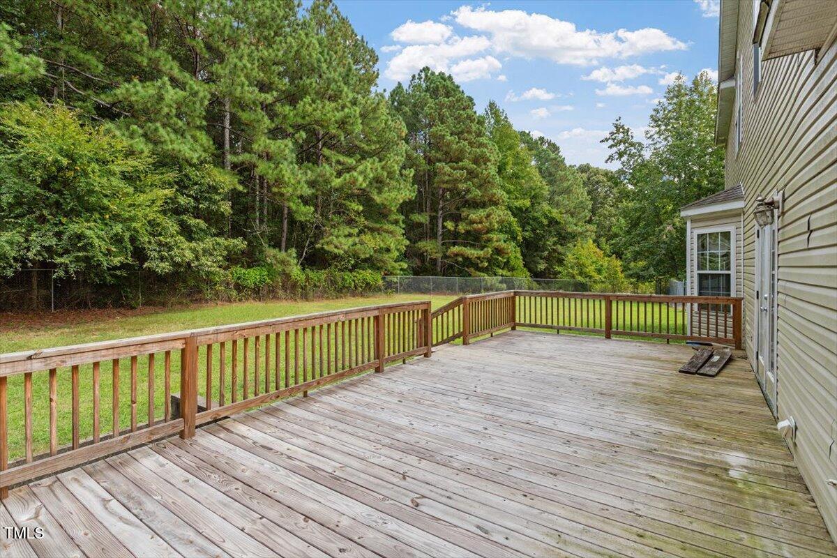 1175 Faulkner Town Road Henderson, NC 27537 - Photo 9 of 48 a view of deck with wooden floor and fence next to a yard