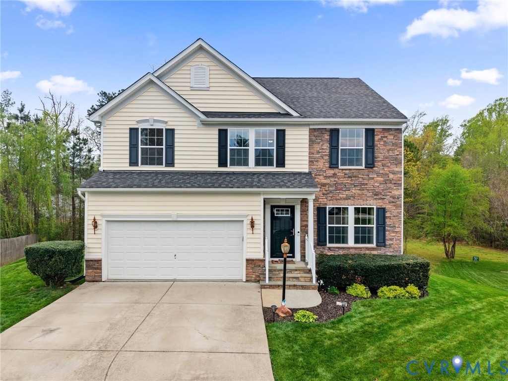 7036 Heartleaf Lane Moseley, VA 23120 - Photo 1 of 28 a front view of a house with a yard and garage