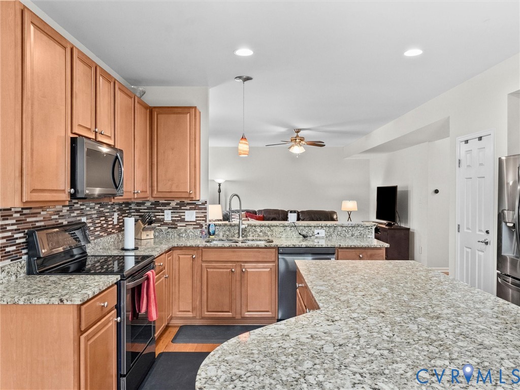 7036 Heartleaf Lane Moseley, VA 23120 - Photo 11 of 28 a kitchen with a sink stove and cabinets