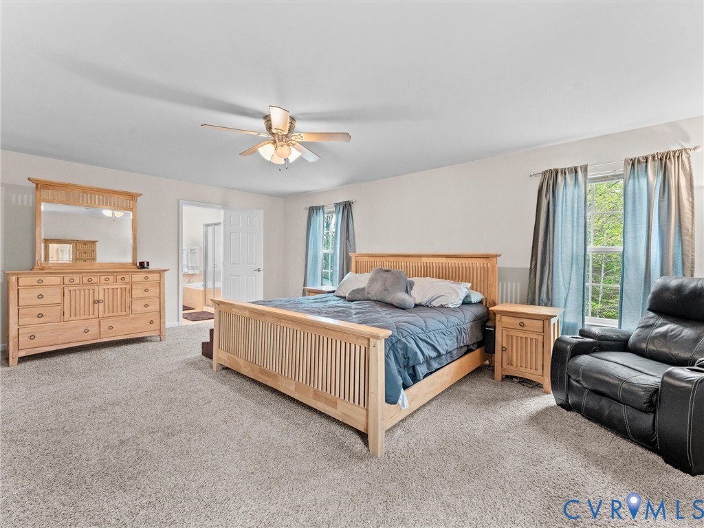 7036 Heartleaf Lane Moseley, VA 23120 - Photo 16 of 28 a bedroom with a bed and a couch