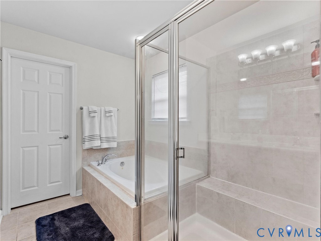 7036 Heartleaf Lane Moseley, VA 23120 - Photo 18 of 28 a bathroom with a bathtub and a shower