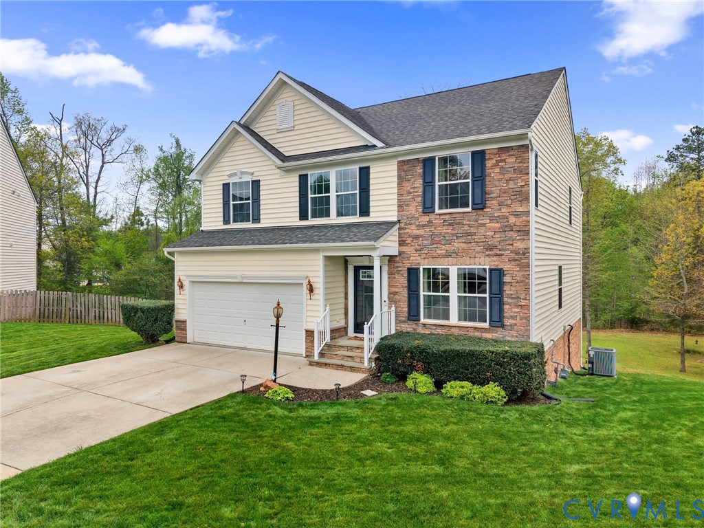 7036 Heartleaf Lane Moseley, VA 23120 - Photo 2 of 28 a view of a white house with a big yard and potted plants