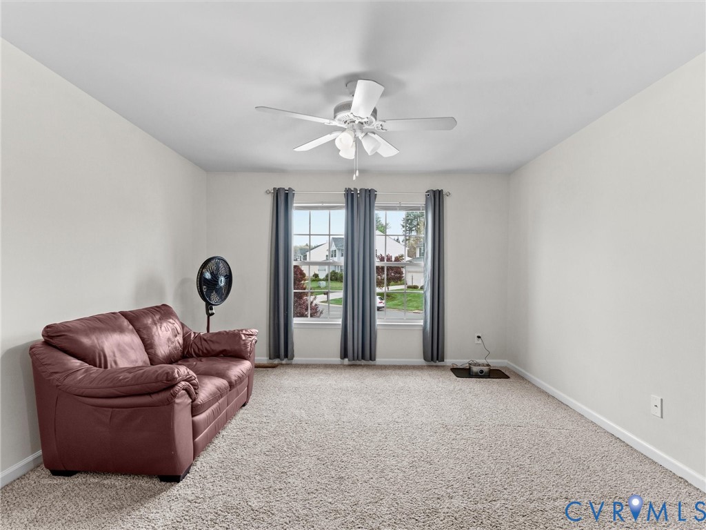 7036 Heartleaf Lane Moseley, VA 23120 - Photo 22 of 28 a living room with furniture and a ceiling fan
