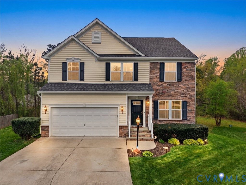 7036 Heartleaf Lane Moseley, VA 23120 - Photo 27 of 28 a front view of a house with a yard and garage