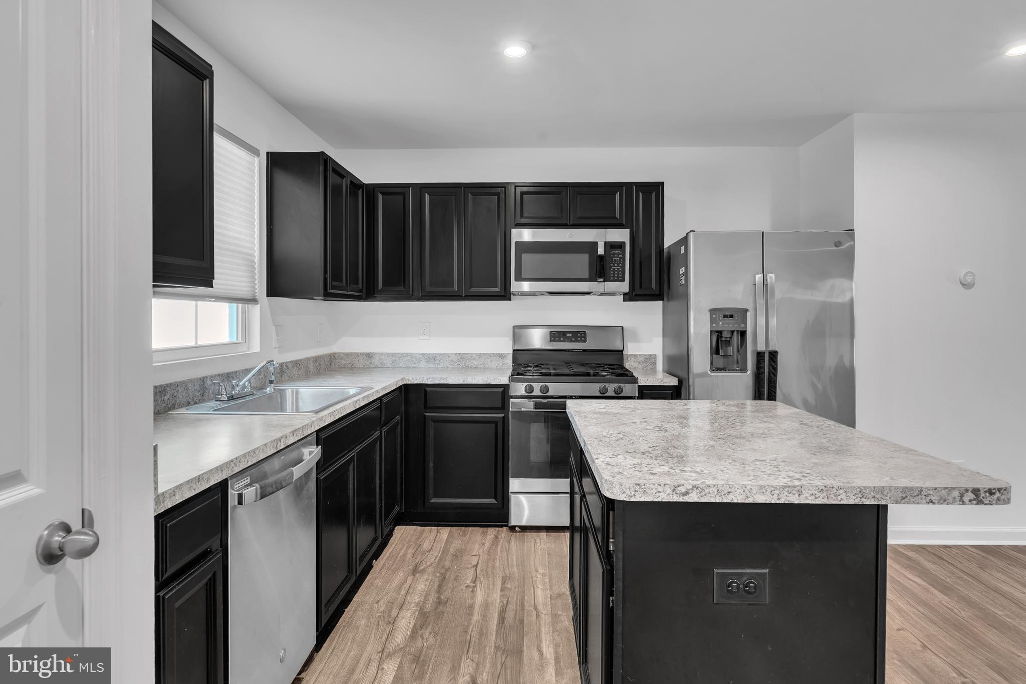 144 Ciseley Drive Sicklerville, NJ 08081 - Photo 19 of 48 a kitchen with kitchen island granite countertop a sink stove and refrigerator