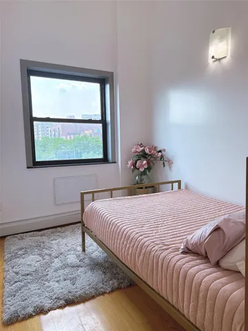 a bedroom with a bed and window