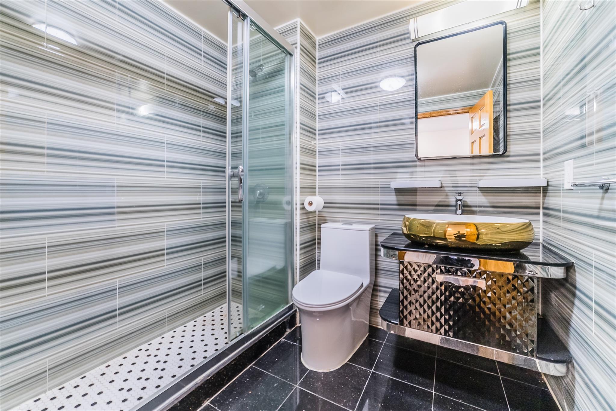 31-47 137th Street, Unit 3C Queens, NY 11354 - Photo 8 of 11 a bathroom with a toilet and a shower