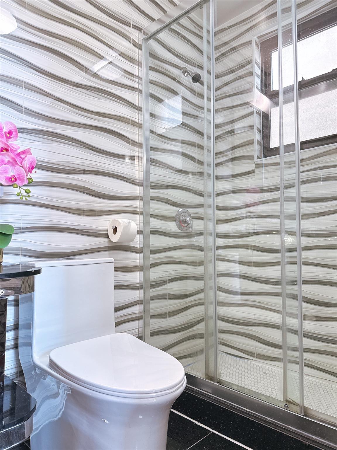 31-47 137th Street, Unit 3C Queens, NY 11354 - Photo 9 of 11 a bathroom with a toilet and a shower