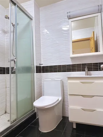 a bathroom with a toilet and a shower