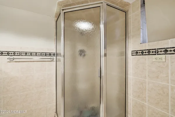 a bathroom with a glass shower door