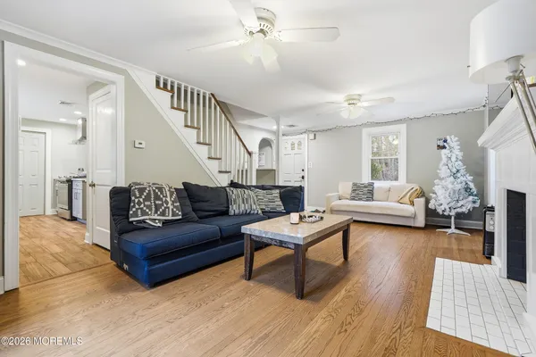a living room with furniture or couch and a wooden floor